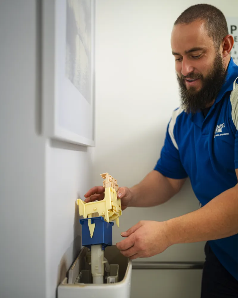 Plumber-repairing-a-toilet